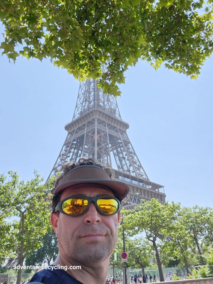 Image of Shane, adventurECO Cycling founder, with the Eiffel Tower in the background during a bike ride around Paris in June 2025.
